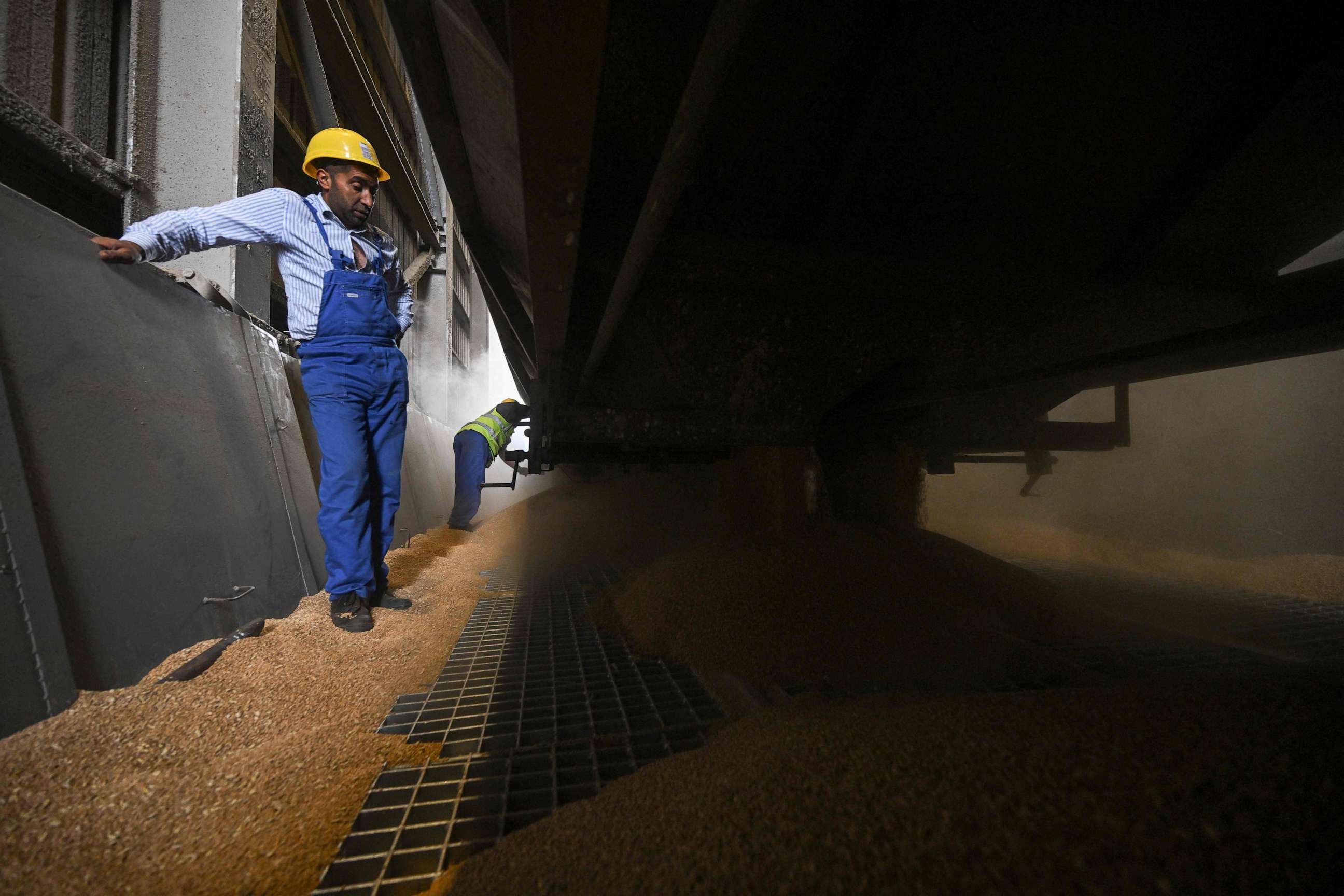 PHOTO: Workers open the hatches of a wheat transporting train car in Constanta harbor, Romania on July 31, 2023. Since the beginning of the war in neighbouring Ukraine, Constanta, the largest port for cereals in Europe.