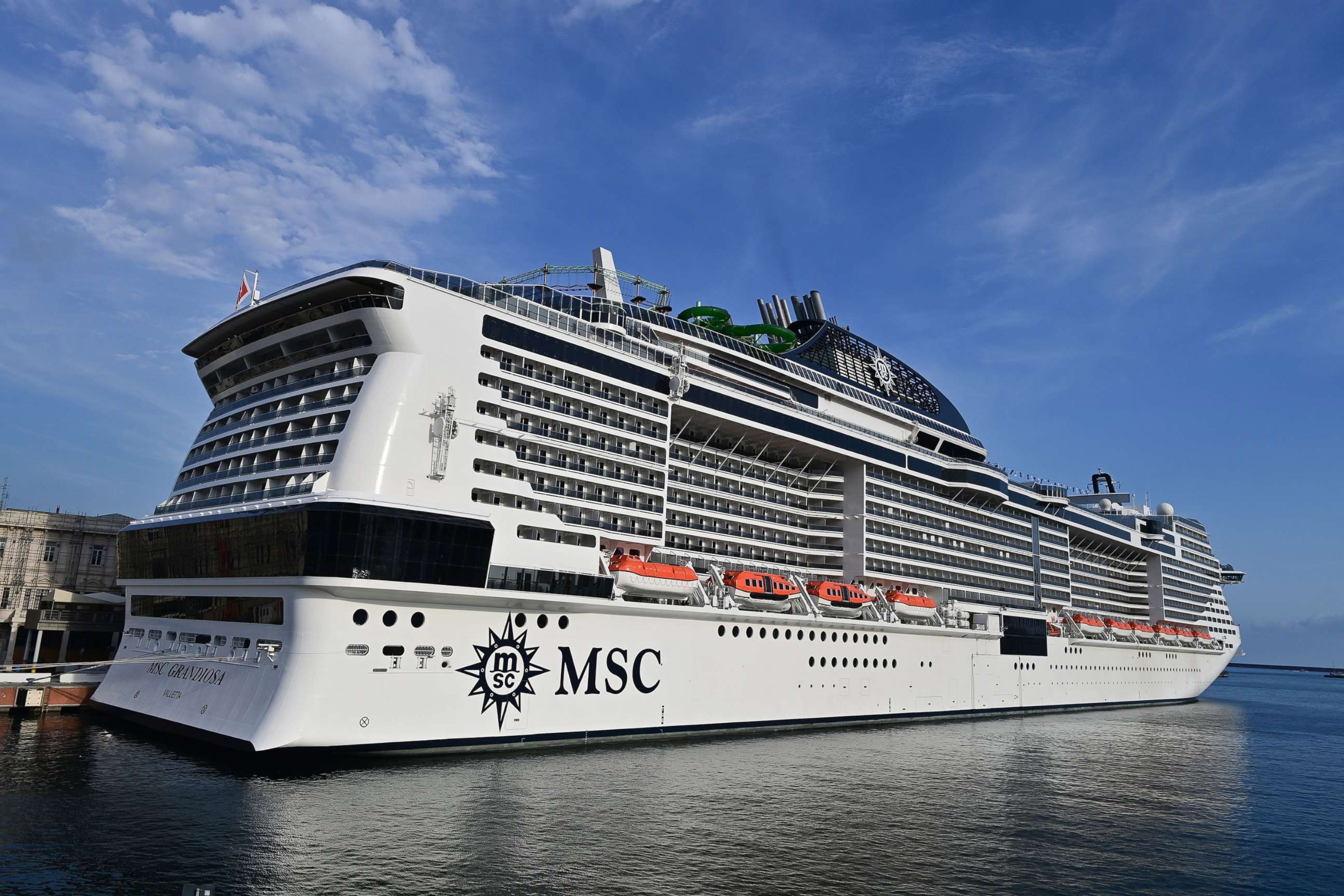 PHOTO: A picture taken in the northern Italian port of Genoa on Aug. 16, 2020, shows the MSC Grandiosa cruise liner leaving the port pulled by a little boat after six-and-half months of inactivity due to the COVID-19 pandemic.