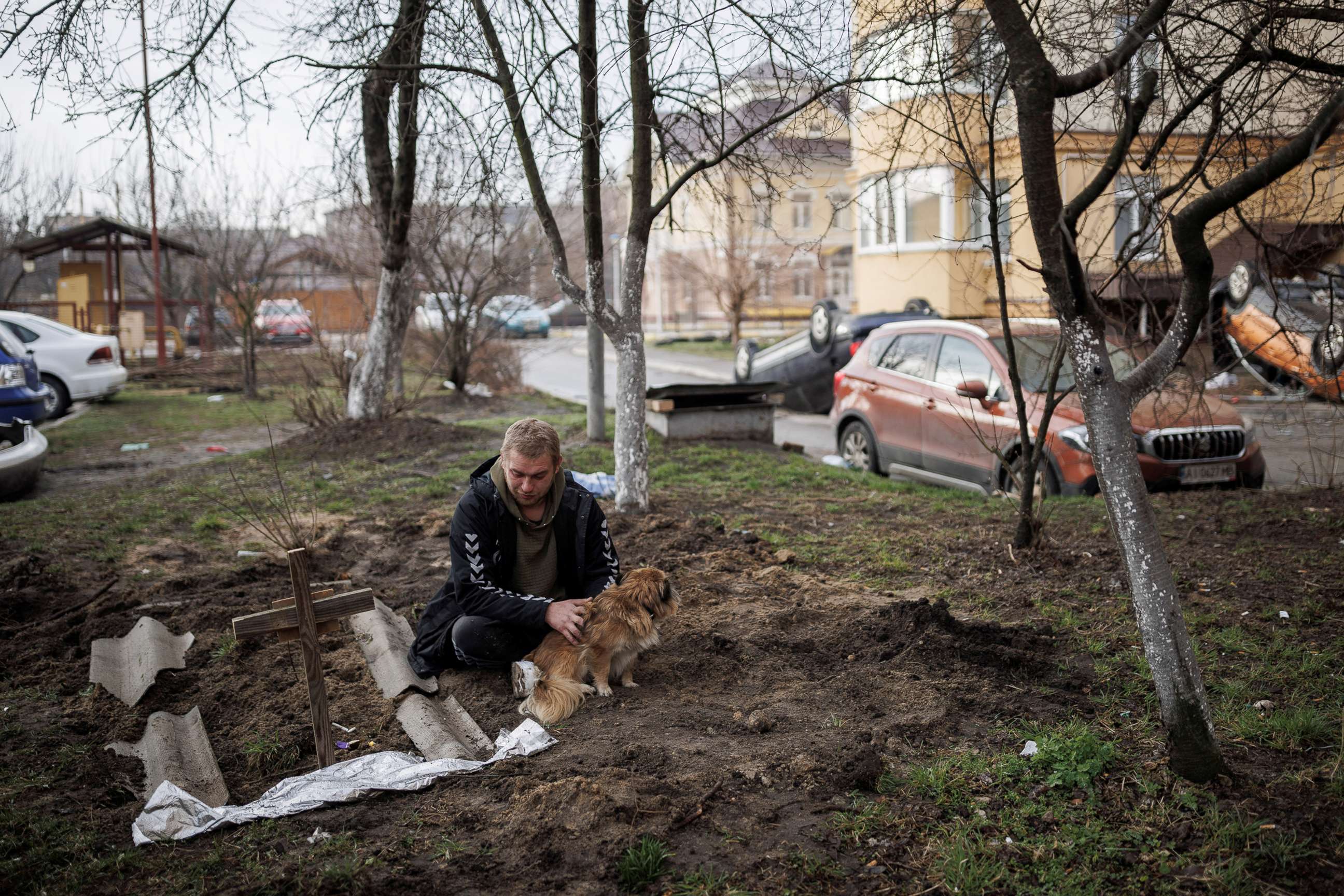 PHOTO: Serhii Lahovskyi, 26, mourns next to the grave of his friend Ihor Lytvynenko, who according to residents was killed by Russian soldiers, after they found him beside a building's basement, in Bucha, Ukraine, April 6, 2022.