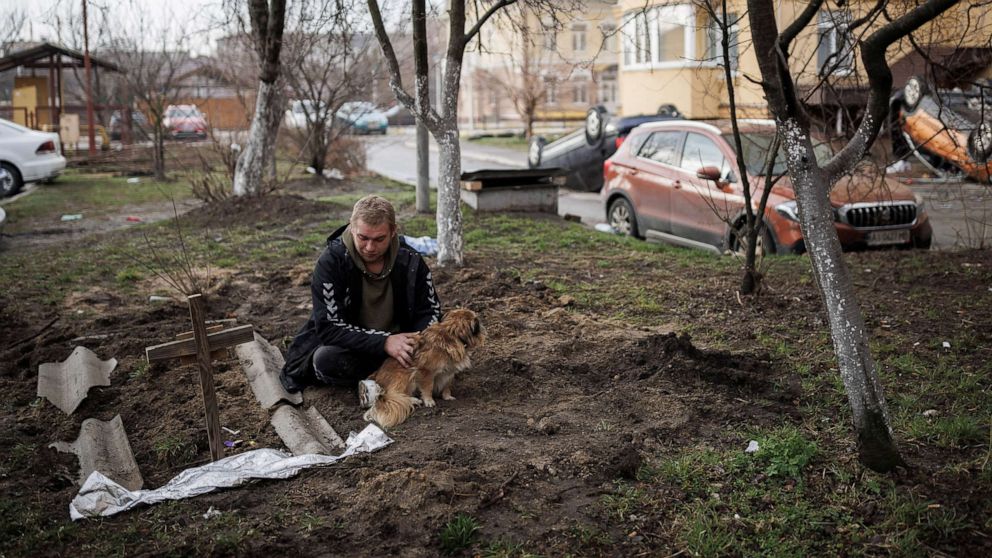 PHOTO: Serhii Lahovskyi, 26, mourns next to the grave of his friend Ihor Lytvynenko, who according to residents was killed by Russian soldiers, after they found him beside a building's basement, in Bucha, Ukraine, April 6, 2022.