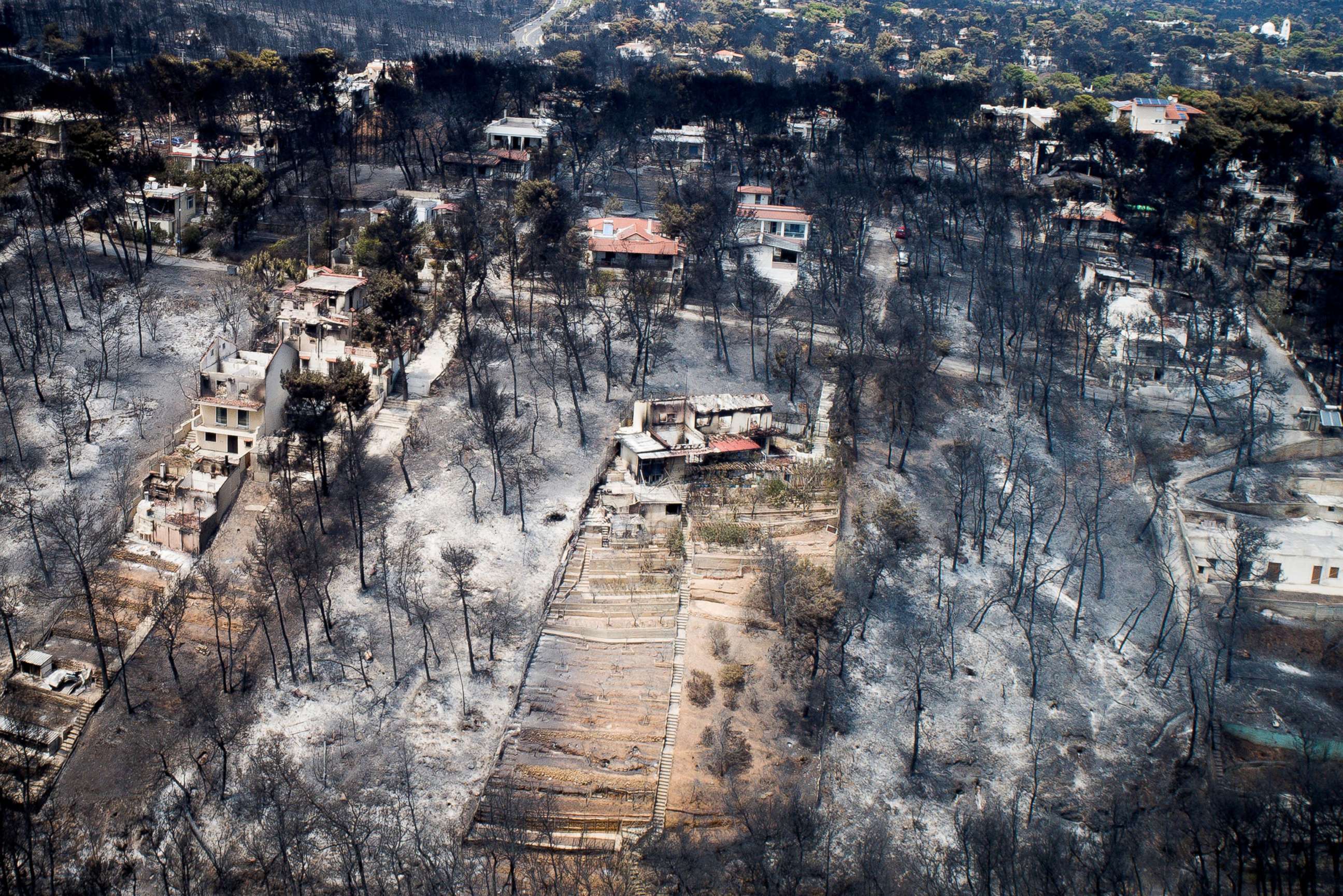 PHOTO: An aerial view shows burnt houses and trees following a wildfire in the village of Mati, near Athens, Greece, July 25, 2018.