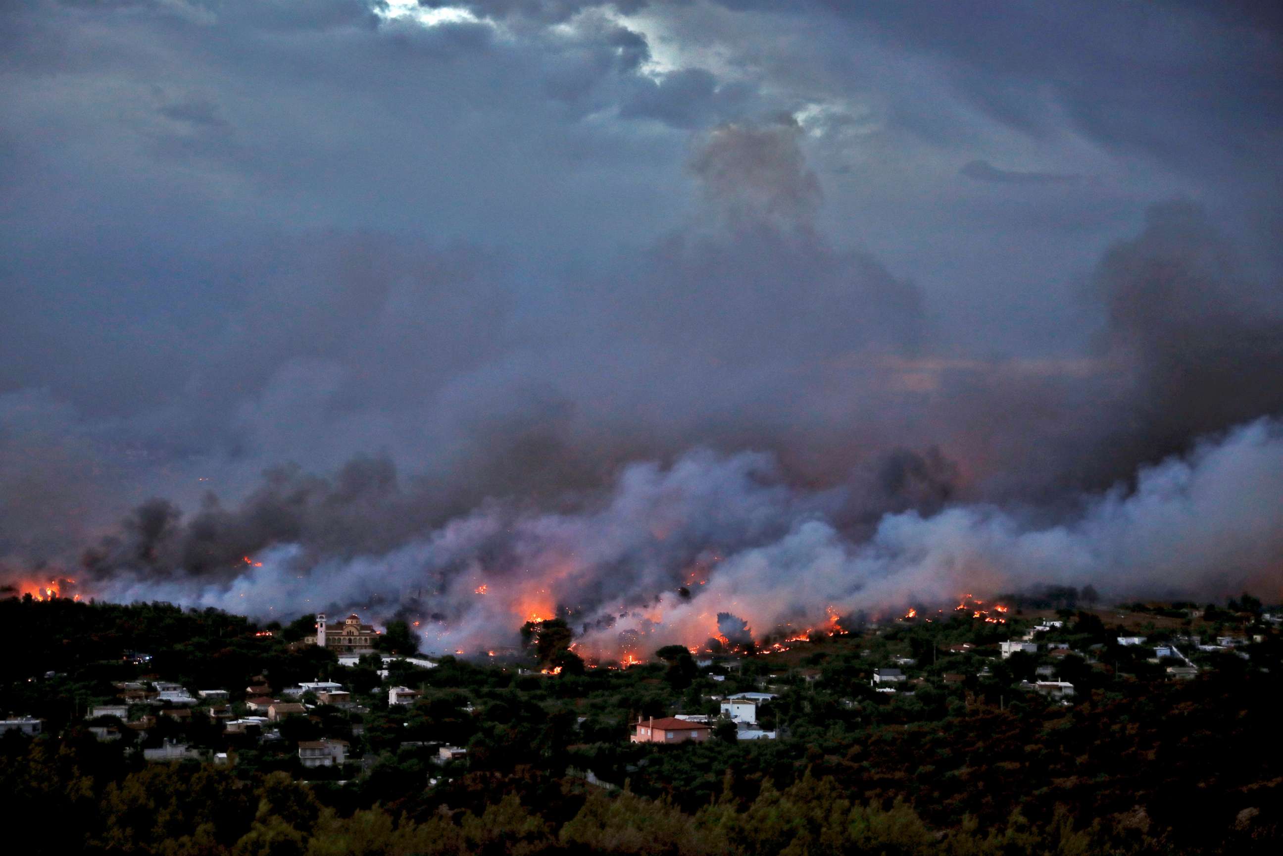 PHOTO: A wildfire rages in the town of Rafina, near Athens, July 23, 2018.