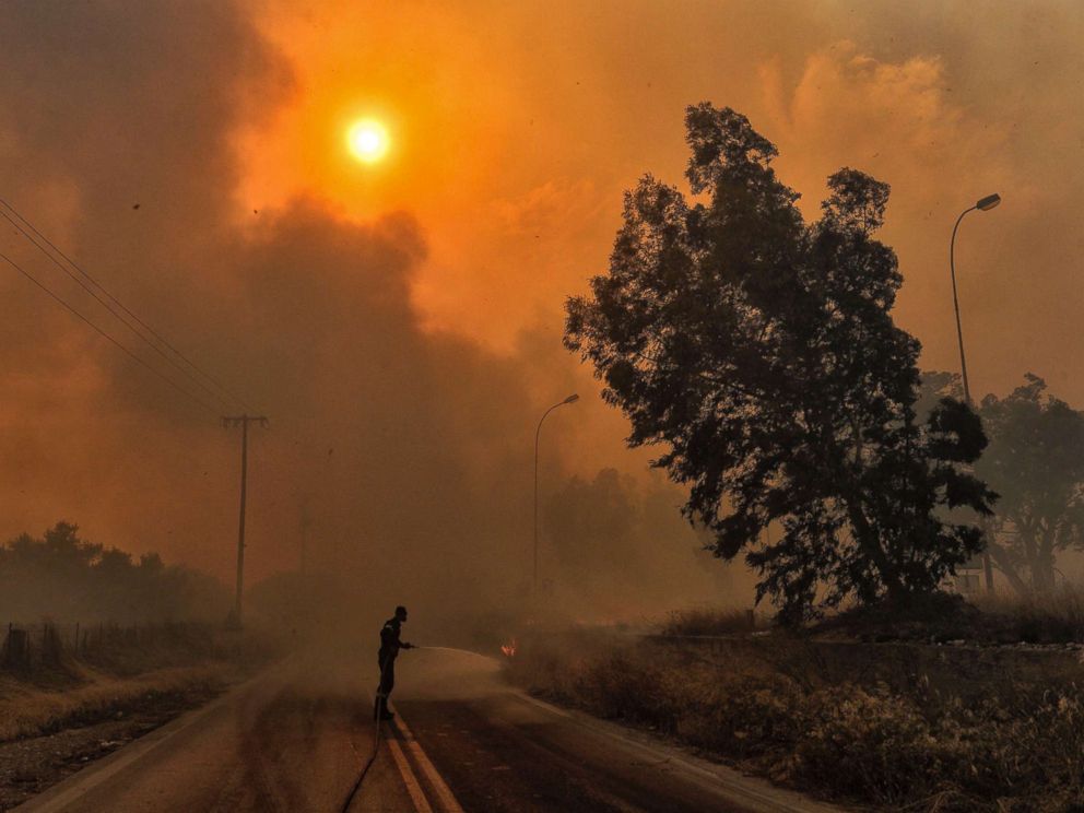 PHOTO: A firefighter tries to extinguish hotspots during a wildfire in Kineta, near Athens, July 23, 2018.