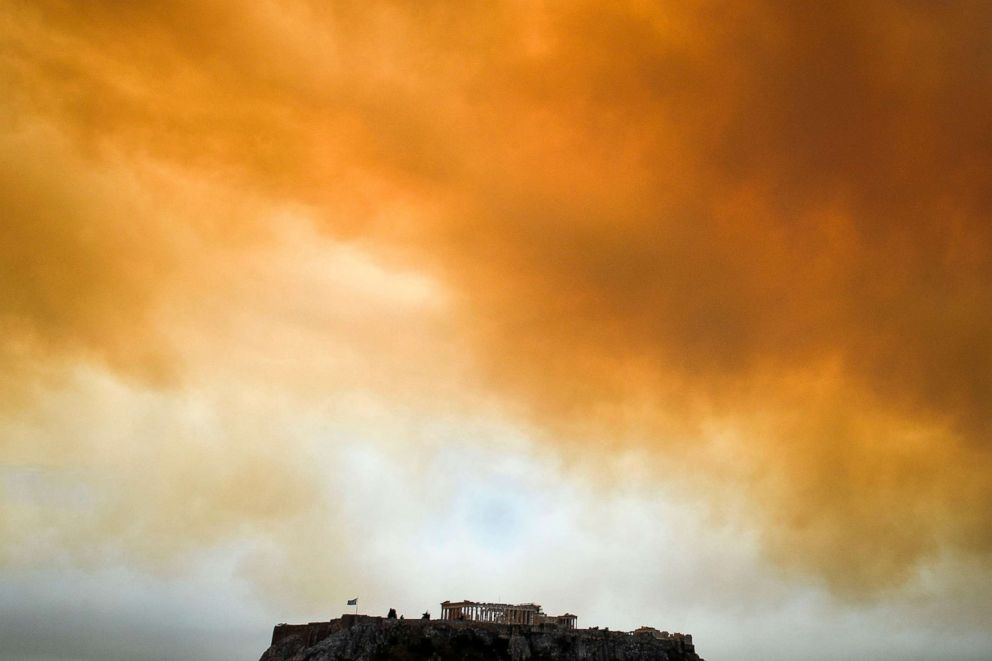 PHOTO:The Parthenon temple on the Acropolis hill in Athens is seen as smoke billows in background during a wildfire in Kineta, near Athens, Greece, July 23, 2018.