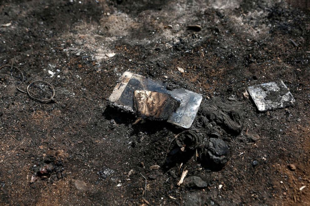 PHOTO: A victim's burned mobile phone is seen following a deadly forest fire in Mati a northeast suburb of Athens, Greece, July 25, 2018.