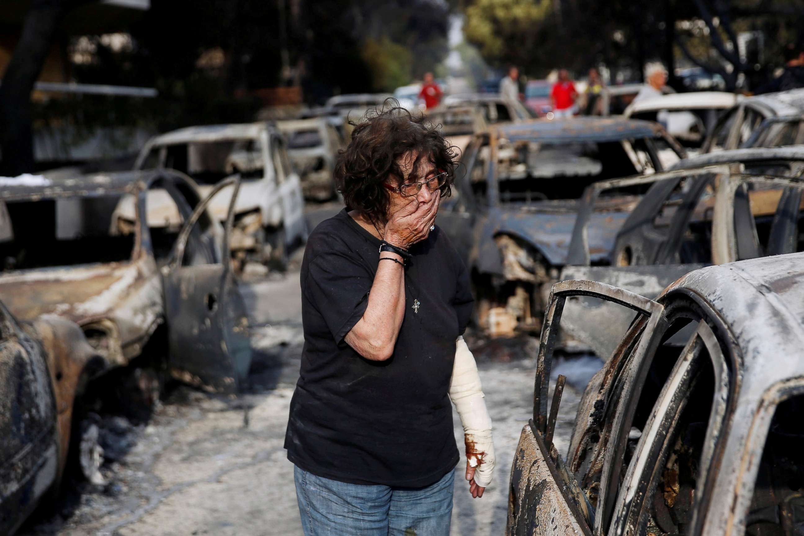 PHOTO: A woman reacts as she tries to find her dog, following a wildfire at the village of Mati, near Athens, Greece, July 24, 2018.