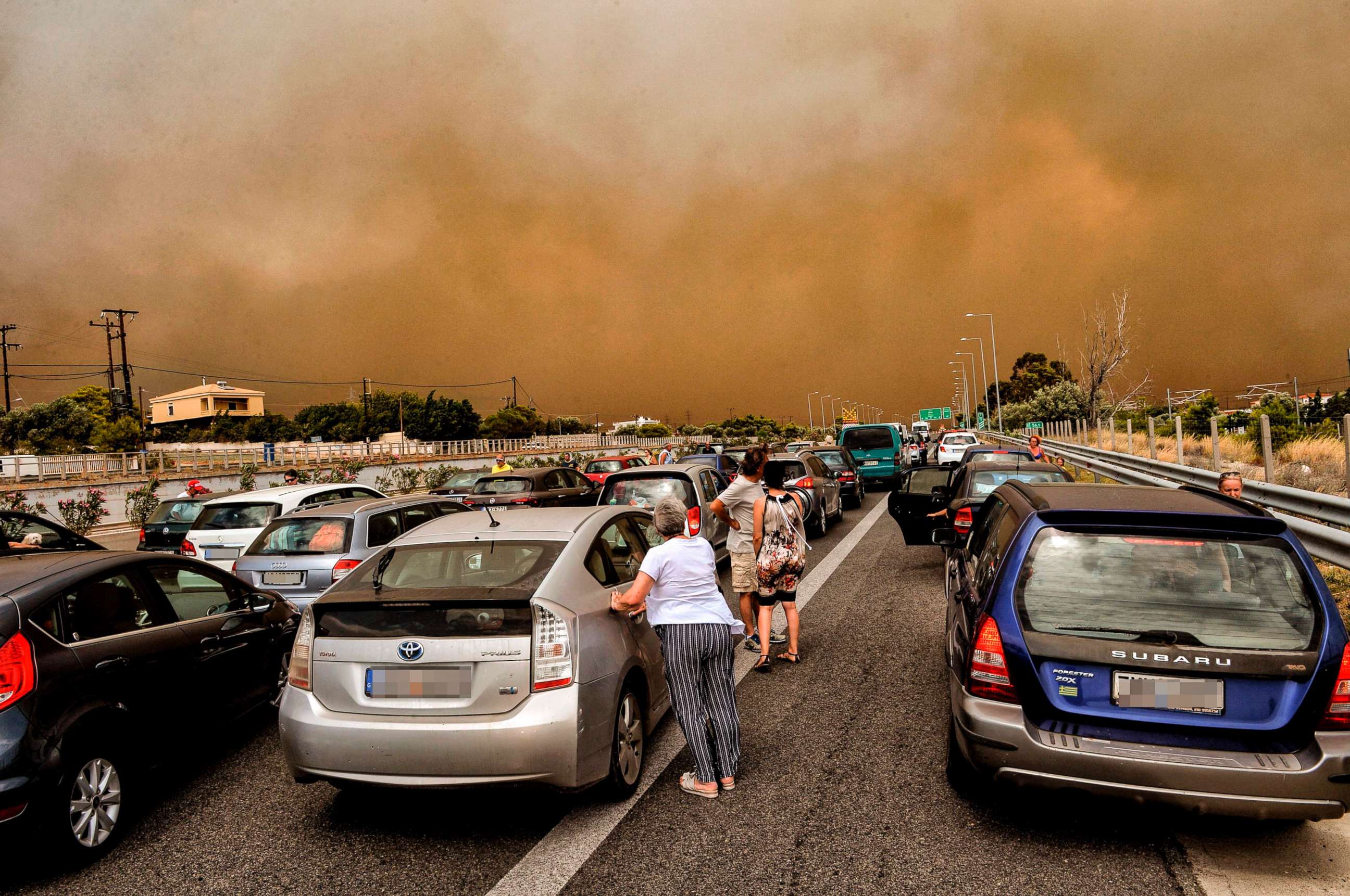 PHOTO: Cars are blocked at the closed National Road during a wildfire in Kineta, near Athens, July 23, 2018.
