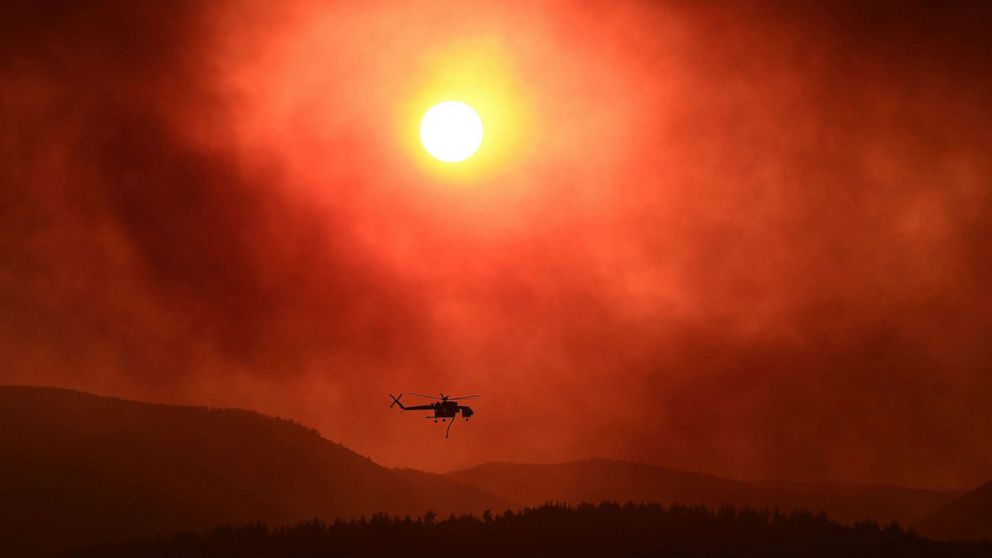 PHOTO: A helicopter flies over as wildfire rages near Alexandroupoli, northern Greece, Aug. 21, 2023.