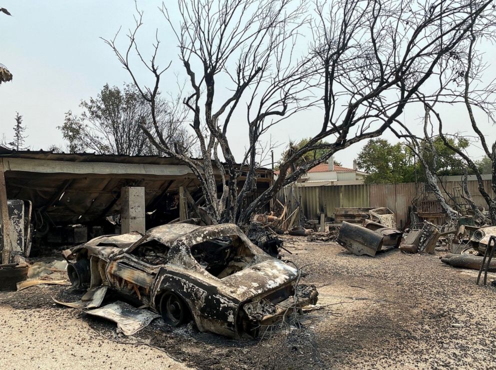 PHOTO: A burned-down home and car in Varympompi, Greece.