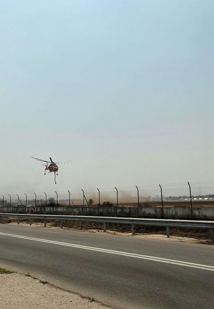 PHOTO: An air tanker hovers above Varympompi, Greece.