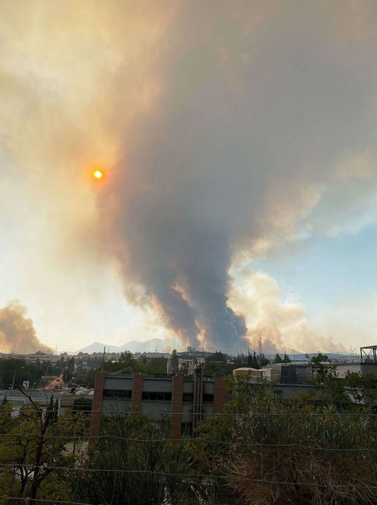 PHOTO: A cloud of smoke billows over the town of Kryoneri, Greece.