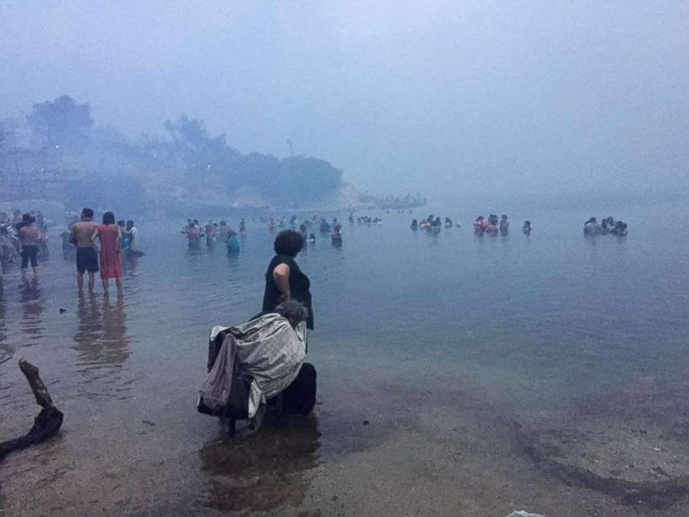 PHOTO: People are seen as a wildfire burns in Mati, Greece, July 23, 2018, in this picture obtained from social media on July 24, 2018. 