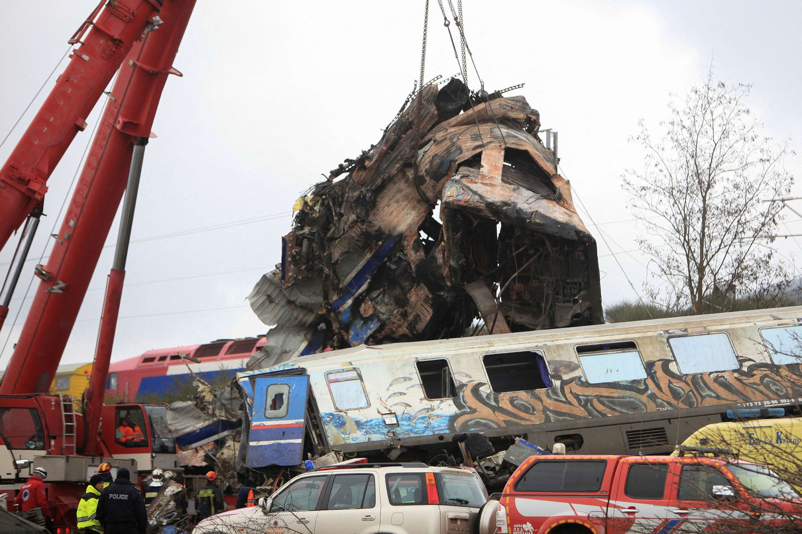 PHOTO: A crane lifts parts of a destroyed carriage as rescuers operate on the site of a crash, where two trains collided, near the city of Larissa, Greece, March 2, 2023.