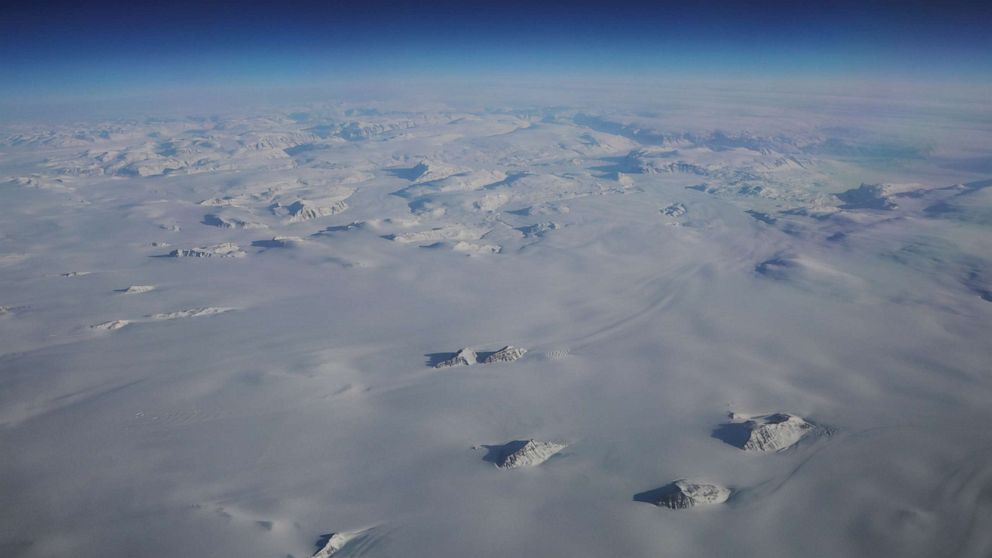 PHOTO: Mountains stick up through a massive ice sheet covering Greenland near the eastern coast of the country, March 13, 2018.