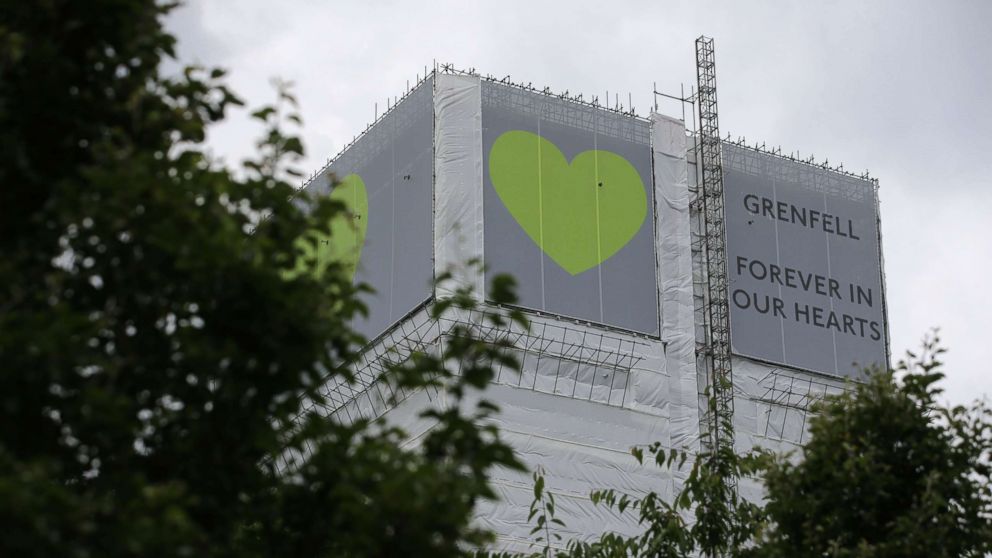 PHOTO: A sign in support of the victims of the Grenfell fire covers Grenfell Tower near Ladbroke Grove, west London on June 13, 2018.