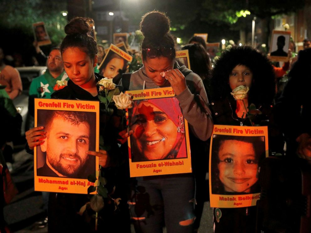 PHOTO: Relatives, survivors and friends of victims of the Grenfell tower fire walk to the tower to hold a vigil, one year after the fire in London, June 13, 2018.
