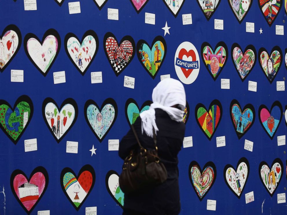 PHOTO: A woman looks at a memorial outside the Notting Hill Methodist Church on the one-year anniversary of the Grenfell Tower fire, June 14, 2018, in London.