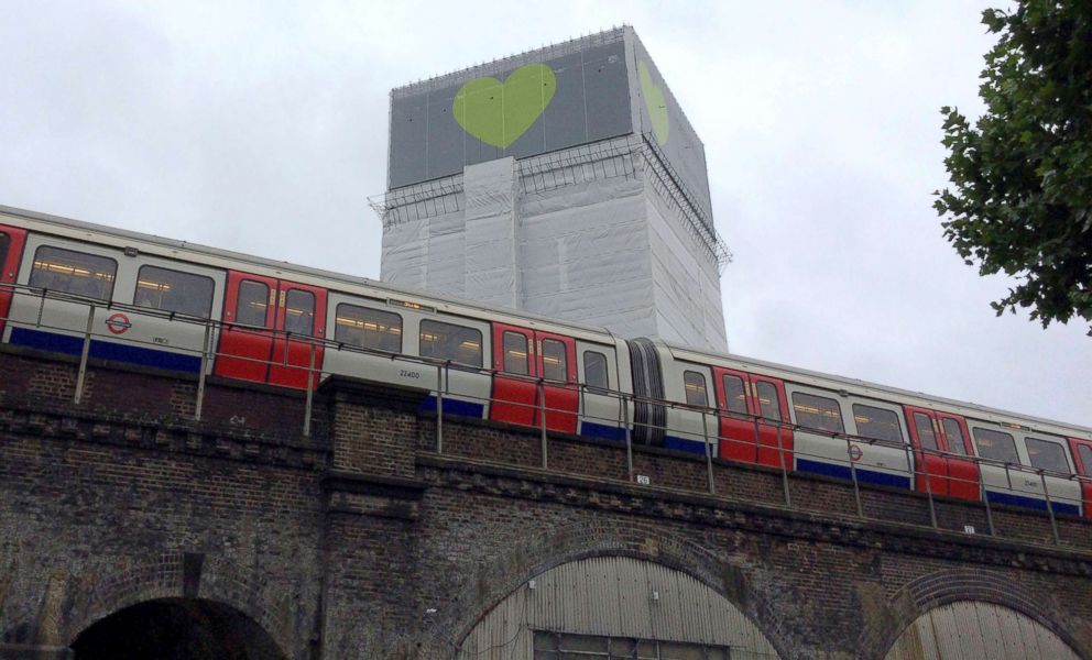 PHOTO: An underground tube train passes Grenfell Tower in London, June 14, 2018.