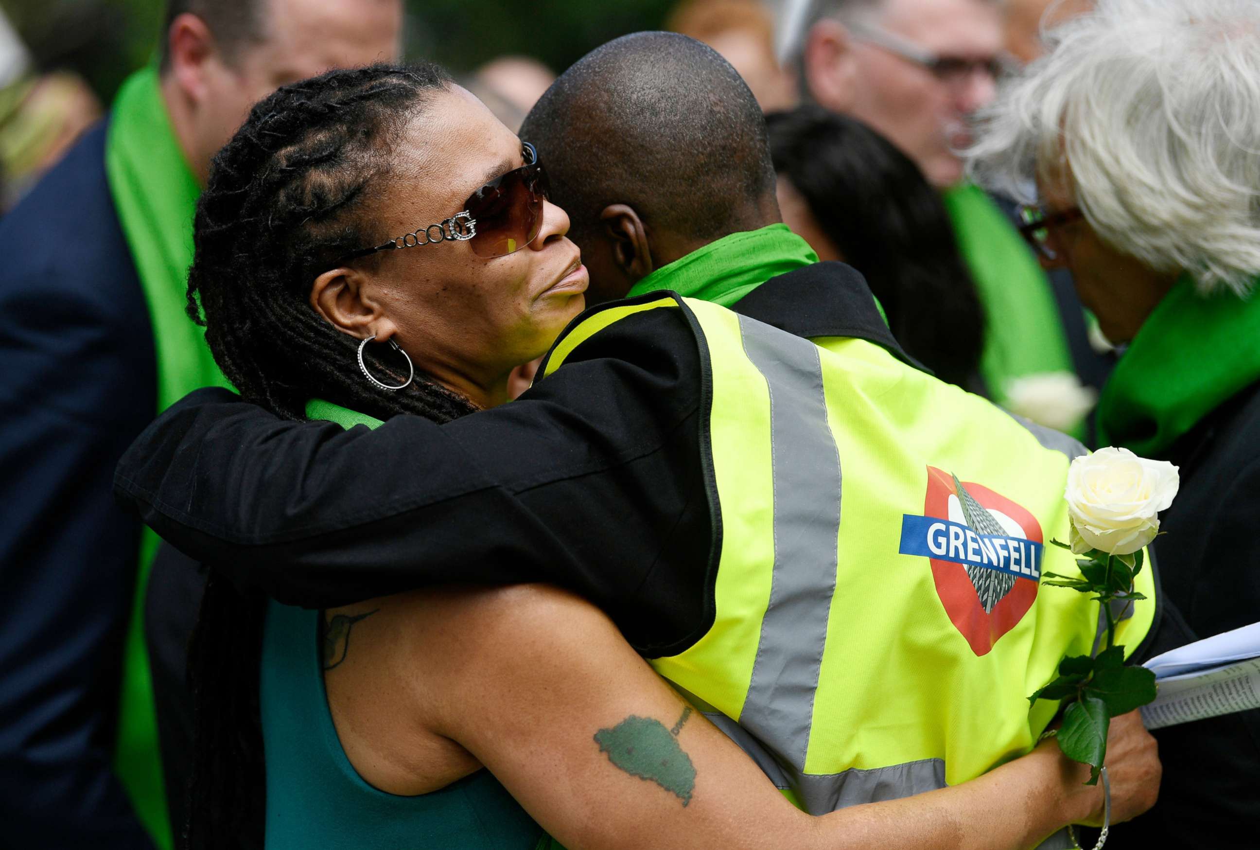PHOTO: Friends and relatives of victims of the Grenfell fire react before taking part in a silent procession, in tribute to victims as they mark one year anniversary of the fire in London, June 14, 2018.
