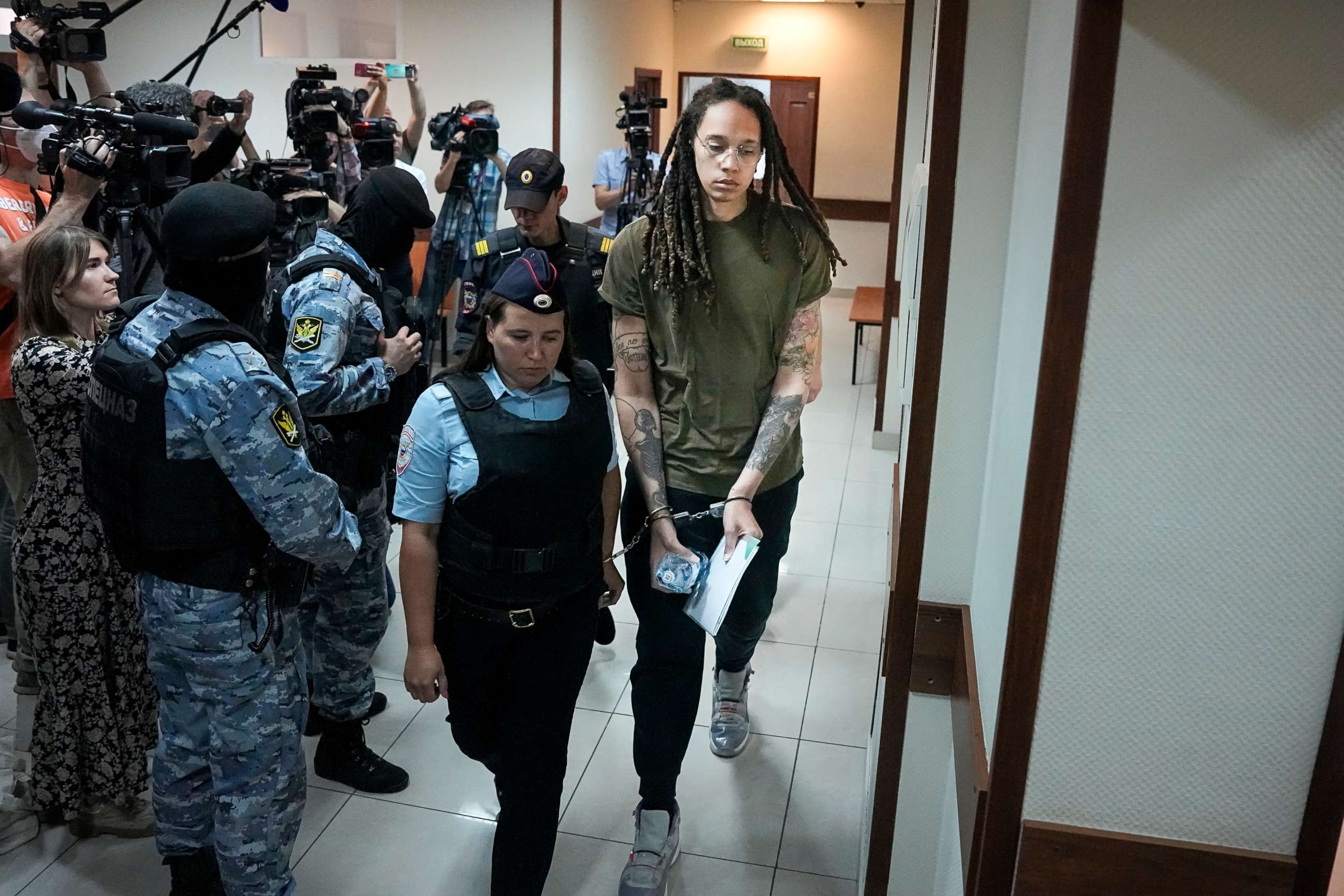 PHOTO: WNBA star and two-time Olympic gold medalist Brittney Griner is escorted in a court room prior to a hearing, in Khimki, just outside Moscow, Russia, on Aug. 2, 2022.