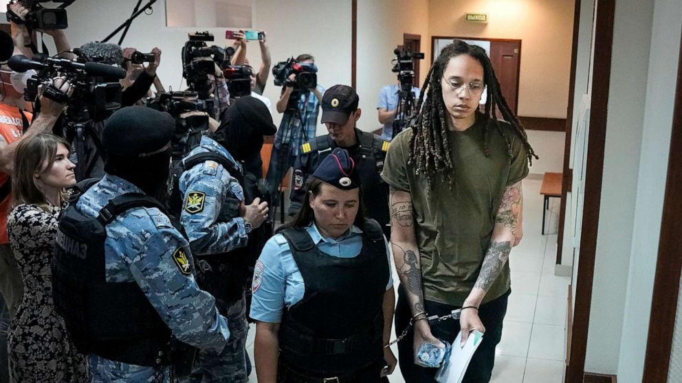 PHOTO: WNBA star and two-time Olympic gold medalist Brittney Griner is escorted in a court room prior to a hearing, in Khimki, just outside Moscow, Russia, on Aug. 2, 2022.