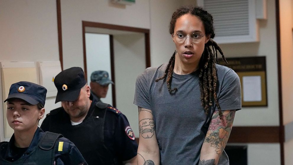 PHOTO: Brittney Griner is escorted from a courtroom after a hearing in Khimki just outside Moscow, Russia, on Aug. 4, 2022. The jailed American basketball star has been moved to a penal colony in Russia, her legal team said Wednesday, Nov. 9, 2022.