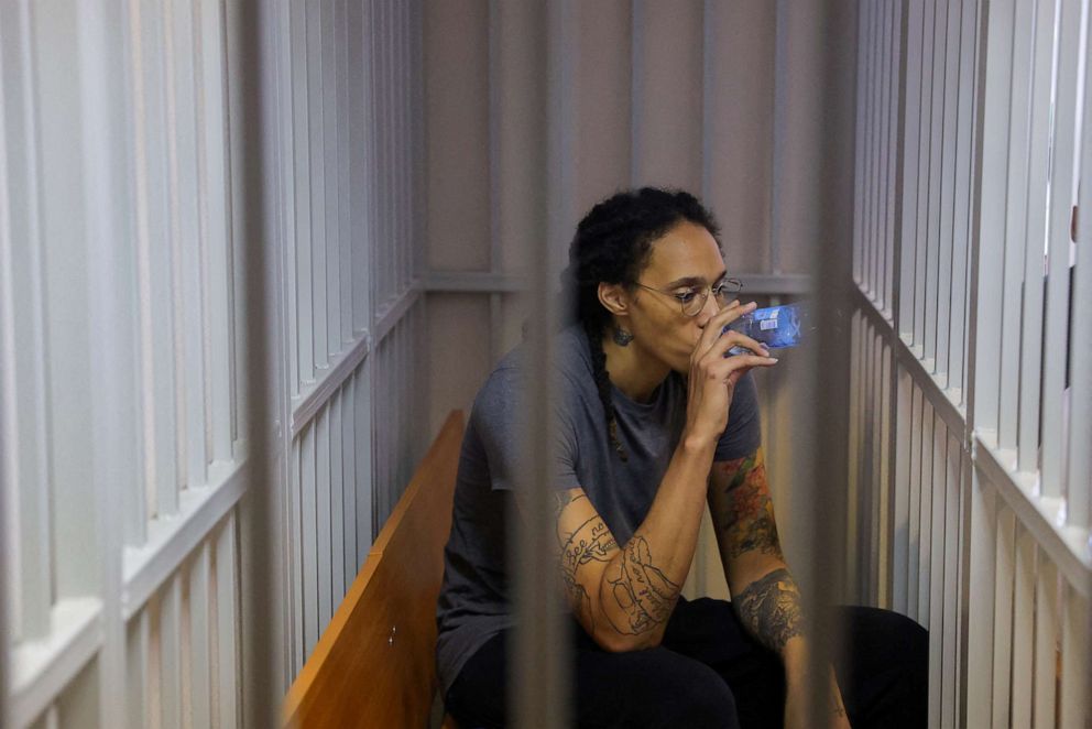 PHOTO: Basketball player Brittney Griner, who was detained at Moscow's Sheremetyevo Airport and later charged with illegal possession of cannabis, drinks water in the cage for the accused after the verdict of a court in Khimki, near Moscow, on August 4, 2022.