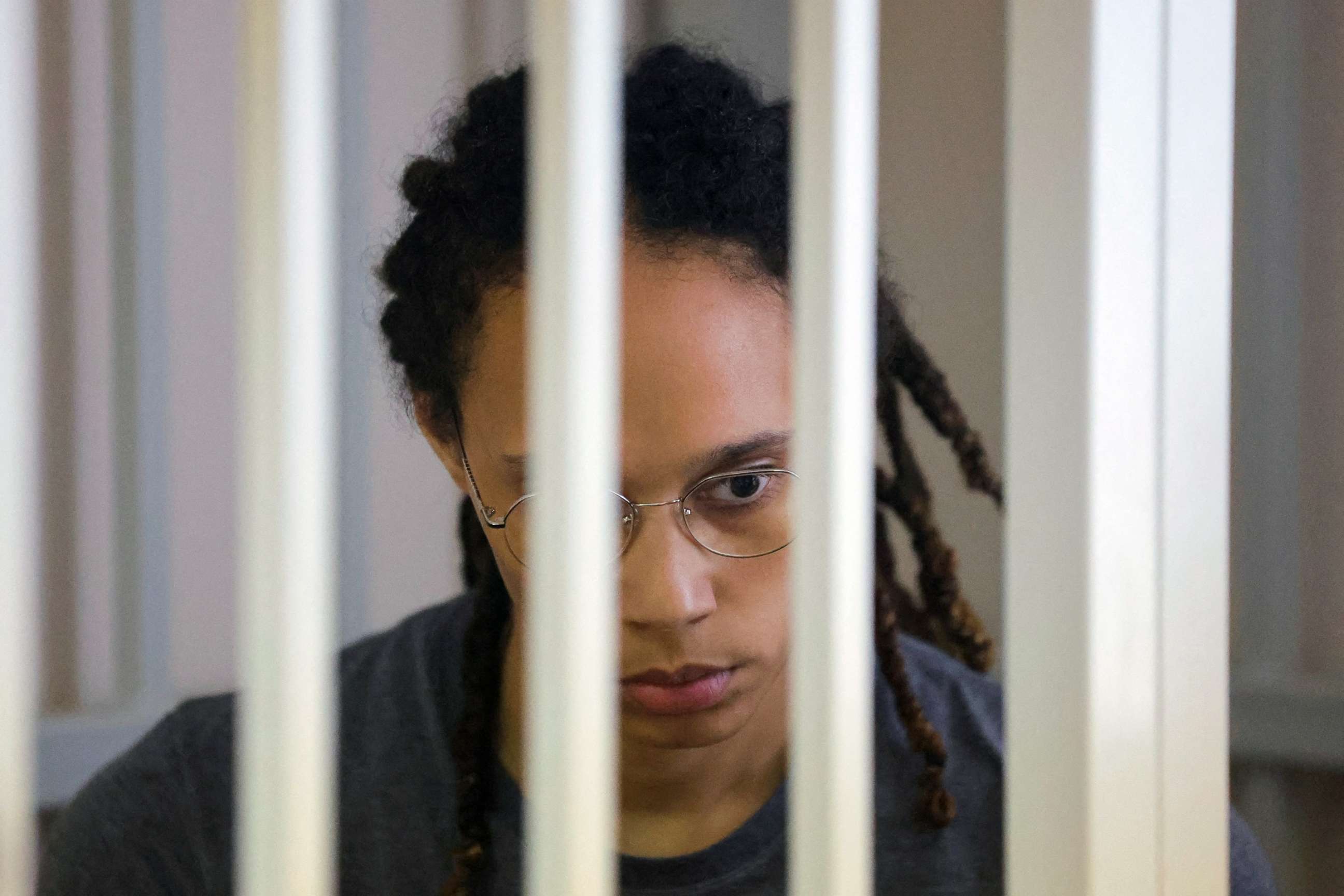 PHOTO: Brittney Griner sits inside a defendants' cage during the reading of the court's verdict in Khimki, Russia, Aug. 4, 2022.