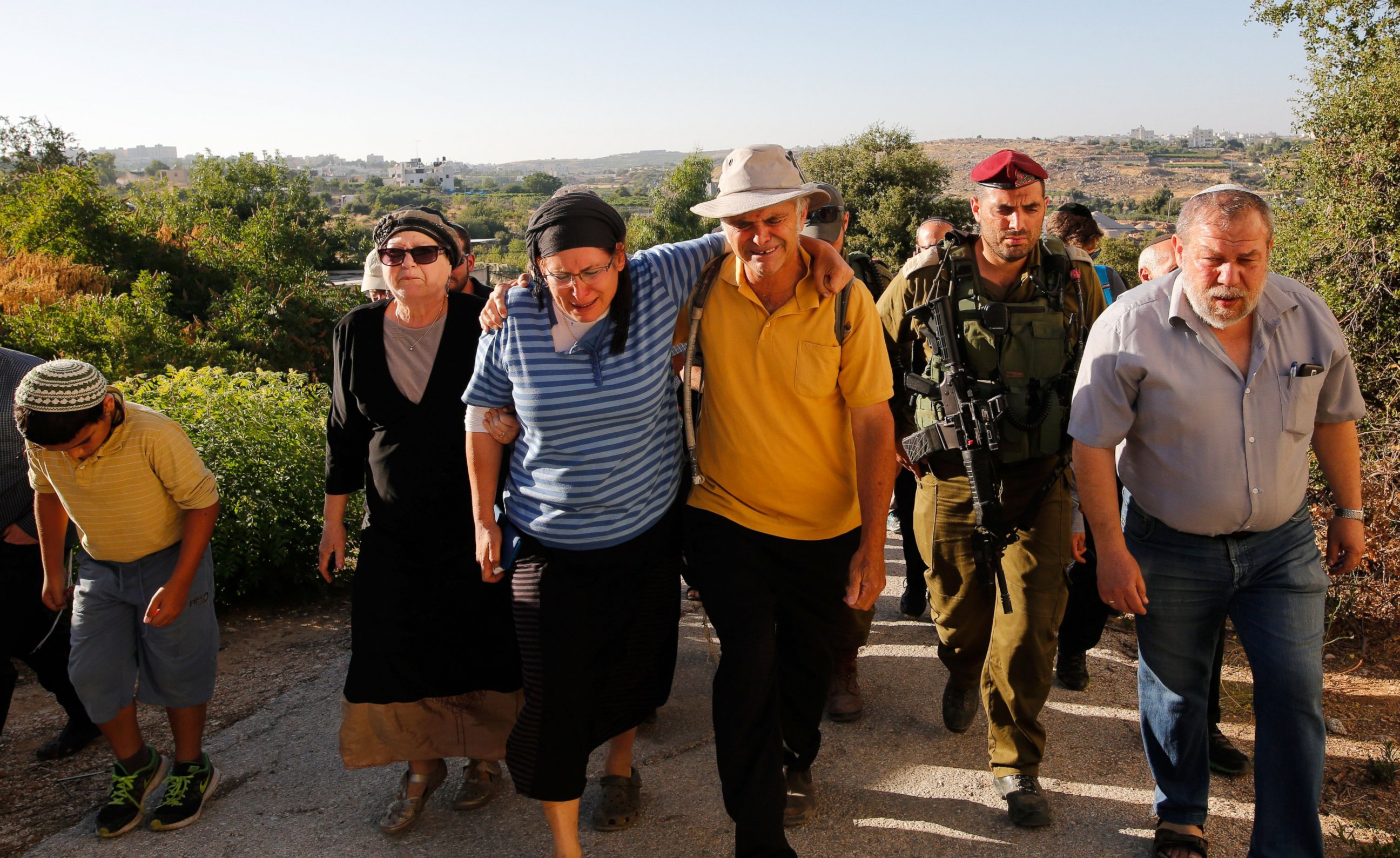 PHOTO: Rina (2-L) and Amihay Yaffe Ariel (3-R) parents of Israeli Hallel, a 13-year-old girl who was fatally stabbed by a Palestinian in her home, mourn during her funeral in Kiryat Arba, outside the West Bank city of Hebron on June 30, 2016. 