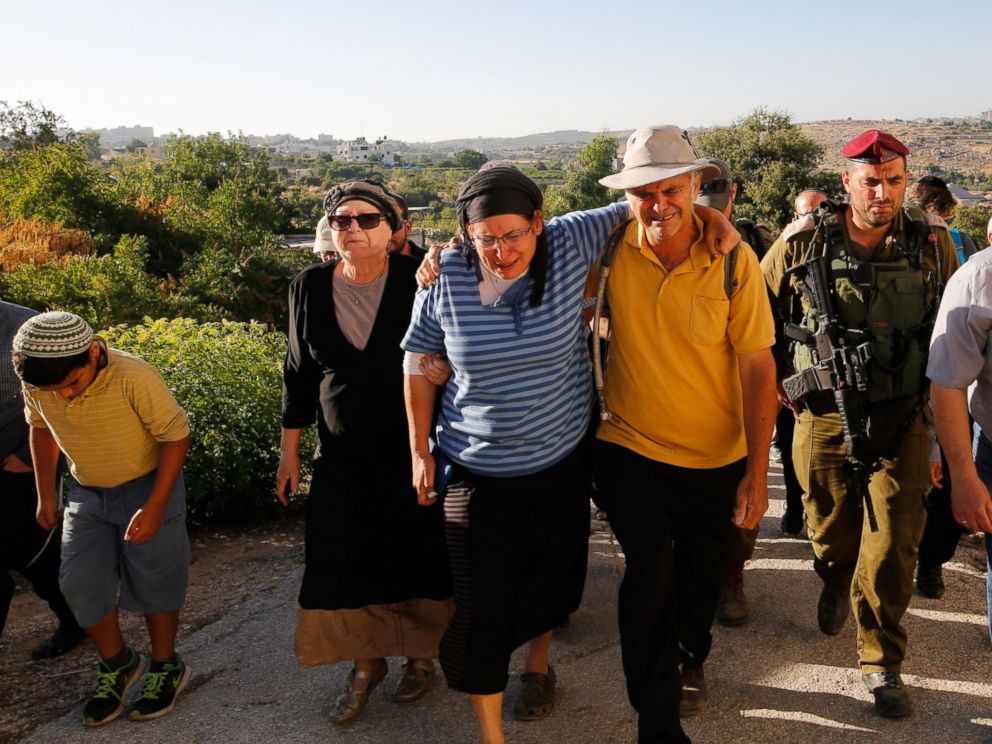 PHOTO: Rina (2-L) and Amihay Yaffe Ariel (3-R) parents of Israeli Hallel, a 13-year-old girl who was fatally stabbed by a Palestinian in her home, mourn during her funeral in Kiryat Arba, outside the West Bank city of Hebron on June 30, 2016.