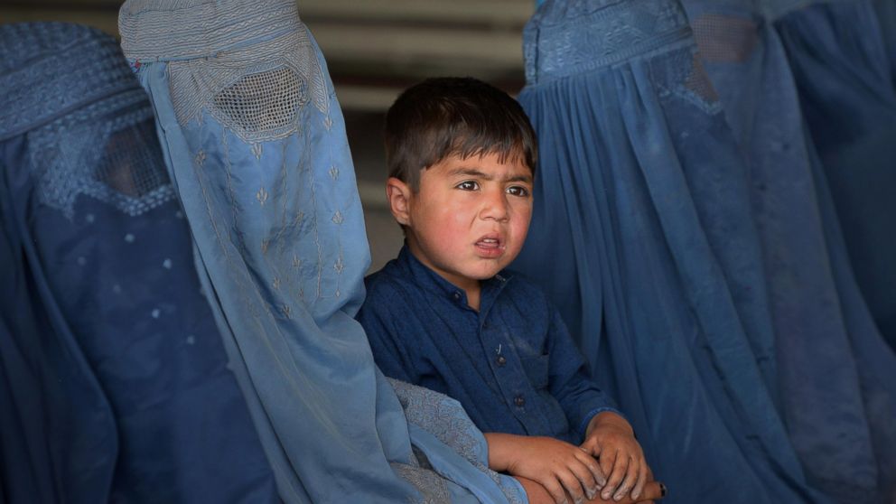 Afghan refugee families wait to be registered at the United Nations High Commissioner for Refugees (UNHCR) repatriation center on the outskirts of Peshawar, April 27, 2017, as they prepare to return to their home country after fleeing civil war and Taliban rule.
