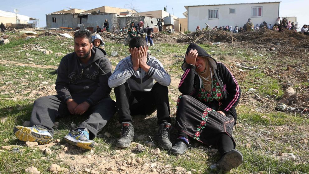 Bedouins cry following the destruction of houses on Jan. 18, 2017 in the Bedouin village of Umm al-Hiran, which is not recognized by the Israeli government, near the southern city of Beersheba. 