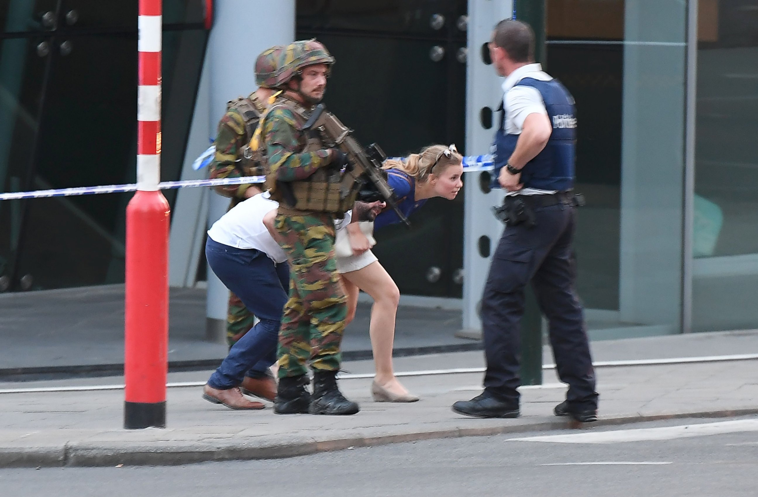 PHOTO: Soldiers and police officials guide members of the public on a street outside Gare Centrale in Brussels on June 20, 2017, after an explosion in the Belgian capital.