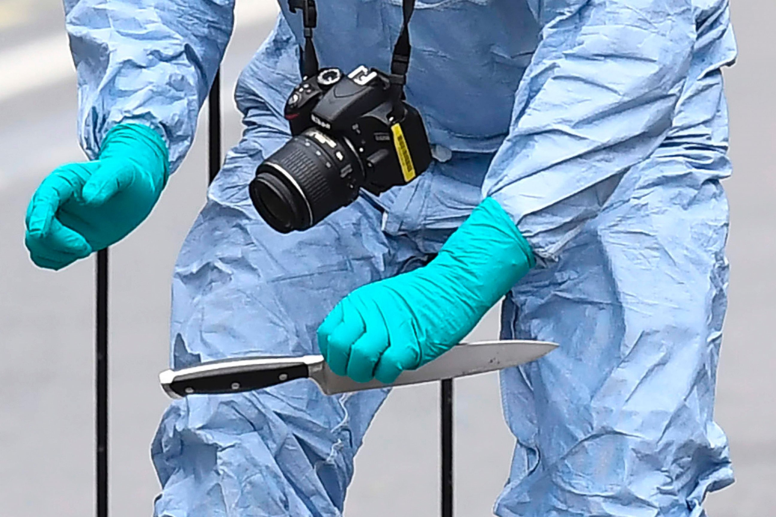 PHOTO: A British police forensics officer holds a knife as evidence is collected on Whitehall near the Houses of Parliament in central London on April 27, 2017, at the scene where a man was detained and taken away by police.