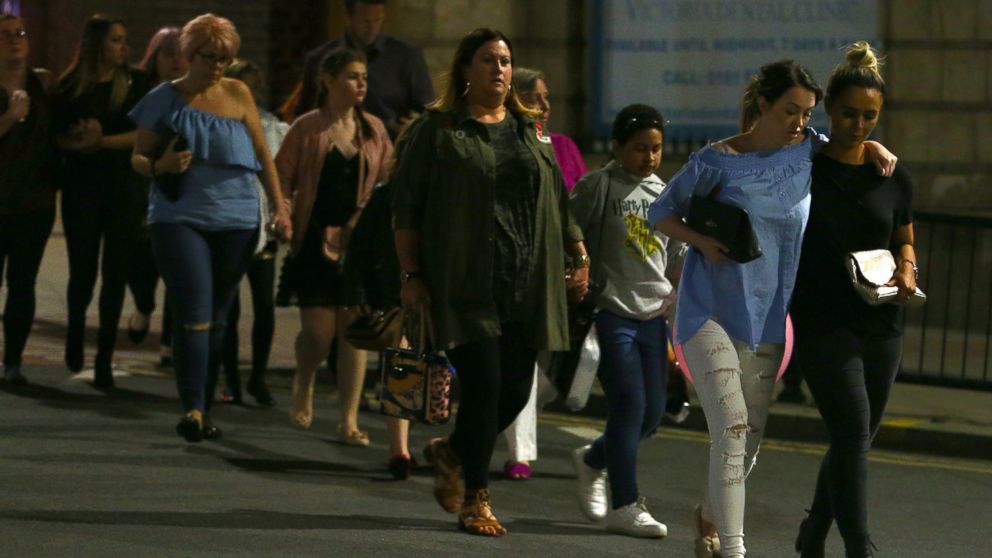 PHOTO: Members of the public are escorted from the Manchester Arena on May 23, 2017 in Manchester, England.