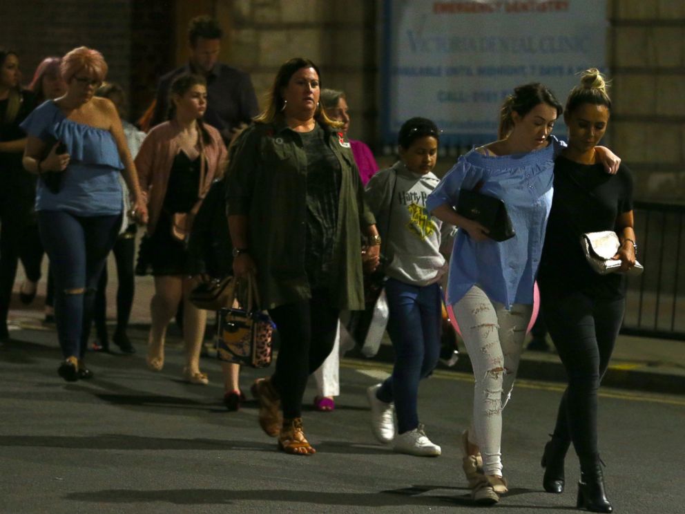 PHOTO: Members of the public are escorted from the Manchester Arena on May 23, 2017 in Manchester, England.