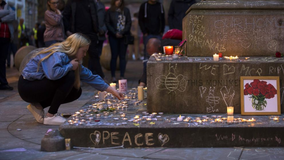 PHOTO: A member of the public lights memorial candles before a vigil in St Ann's Square in Manchester, north west England on May 29, 2017, placed in tribute to the victims of the May 22 terror attack at the Manchester Arena.

