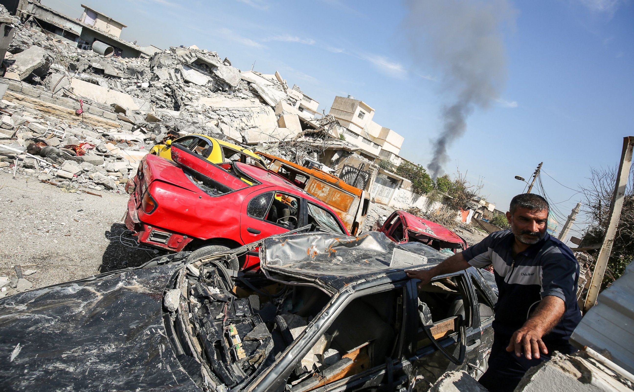 PHOTO: An Iraqi man climbs through the rubble in a heavily damaged street in the Mosul al-Jadida neighbourhood in the northern Iraqi city of Mosul on April 5, 2017.