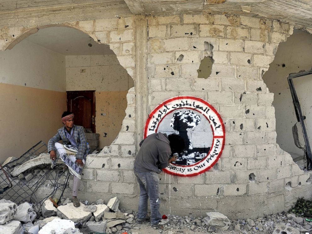 PHOTO: Yemeni graffiti artist Murad Subay creates a piece on a wall to commemorate the victims who were killed in Saudi-led coalition airstrikes in Sanaa, Yemen on June 13, 2015.