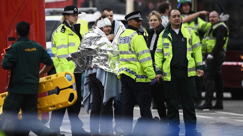 A member of the public is treated by emergency services near Westminster Bridge and the Houses of Parliament on March 22, 2017 in London.