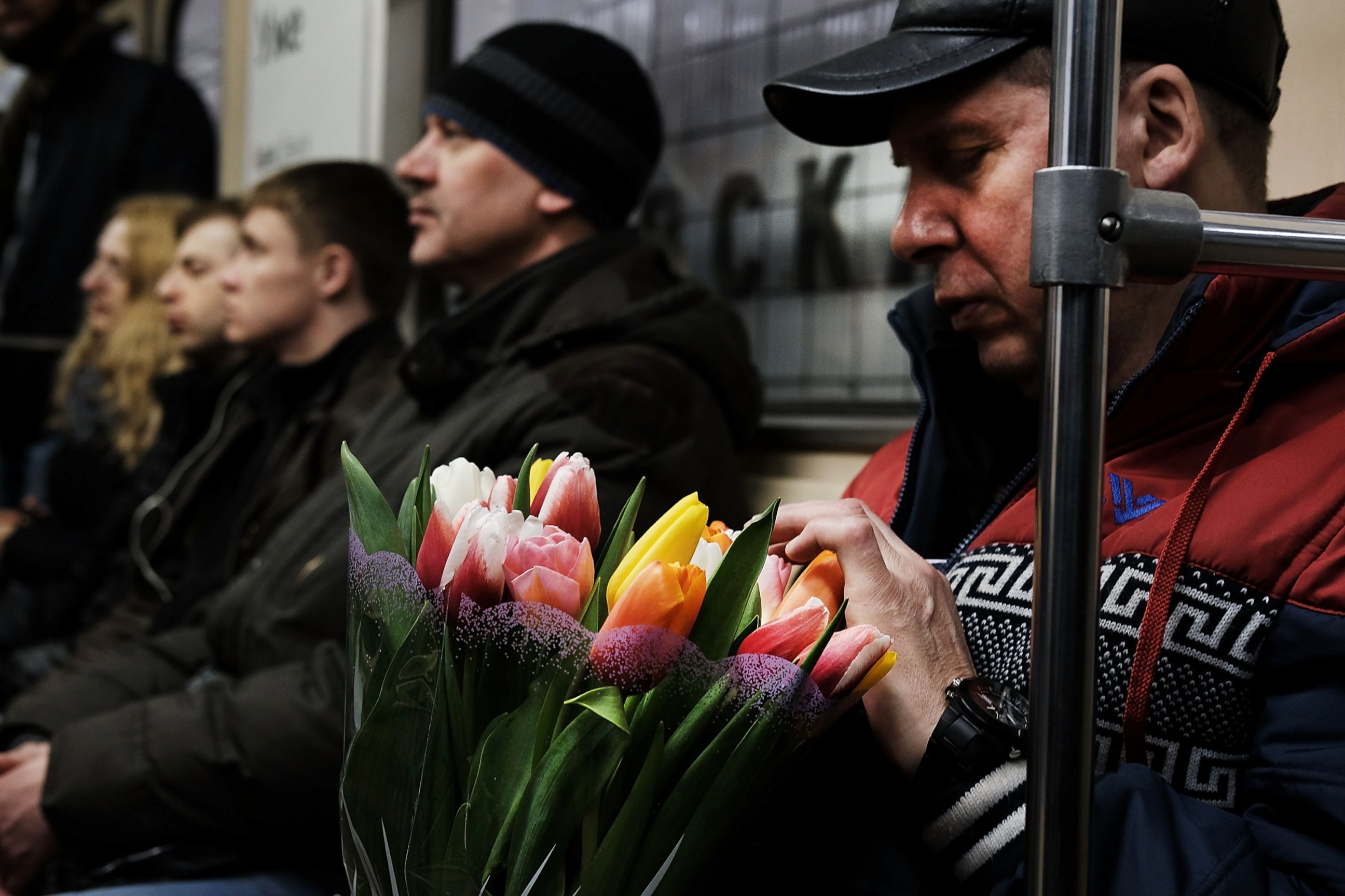 PHOTO: A man holds flowers while riding a Moscow subway on March 6, 2017.