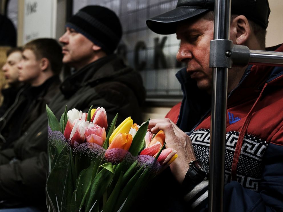 PHOTO: A man holds flowers while riding a Moscow subway on March 6, 2017.