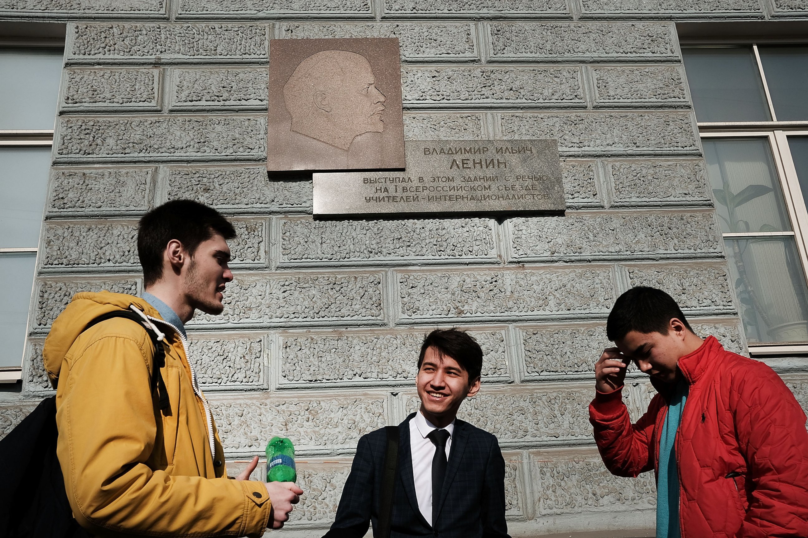 PHOTO: Students stand under a picture of Vladimir Lenin in downtown Moscow on March 9, 2017.