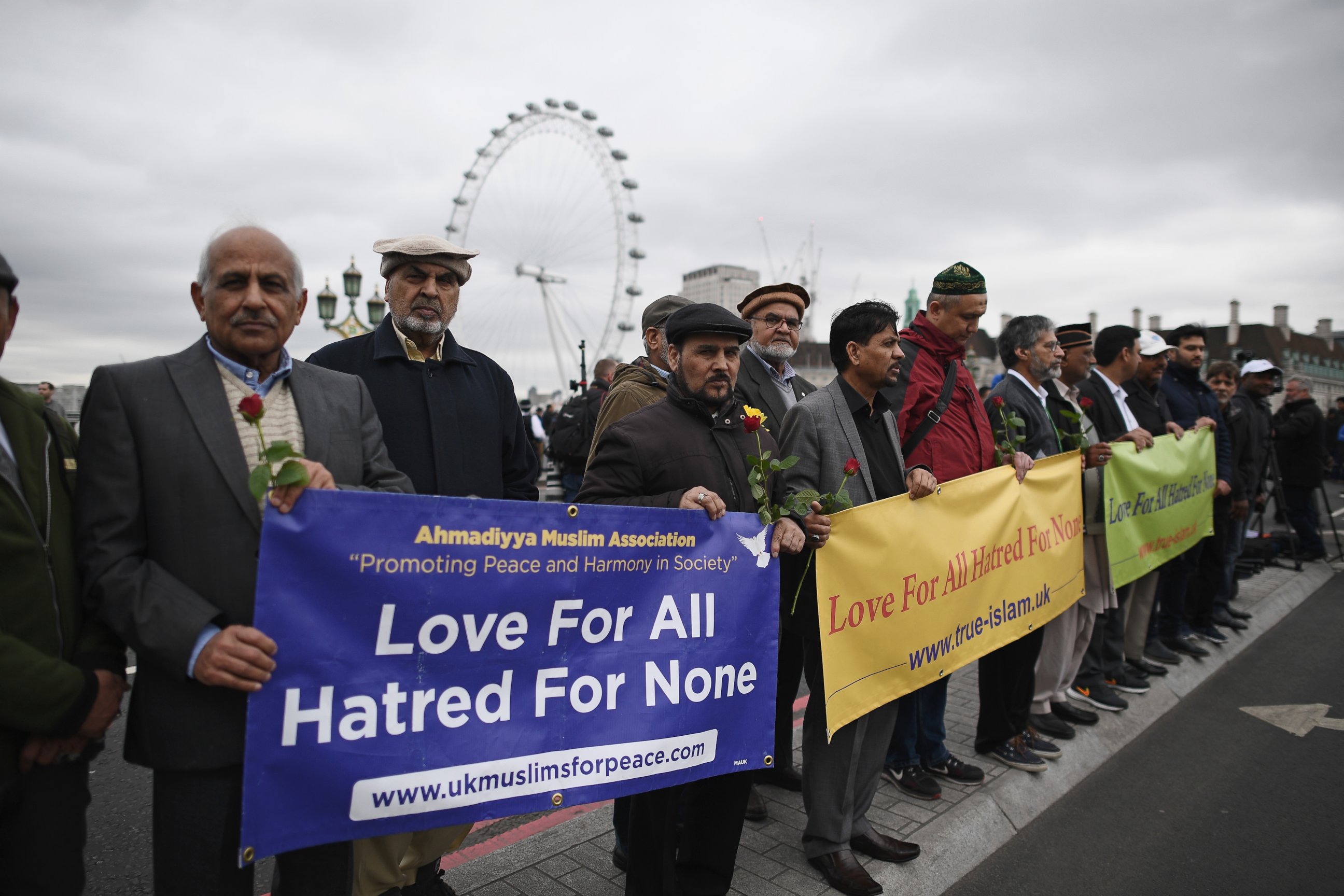 PHOTO: People hold a banner reading "Love for all, hatred for none" on Westminster Bridge as they attend a vigil to remember the victims of last week's Westminster terrorist attack, March 29, 2017, in London.