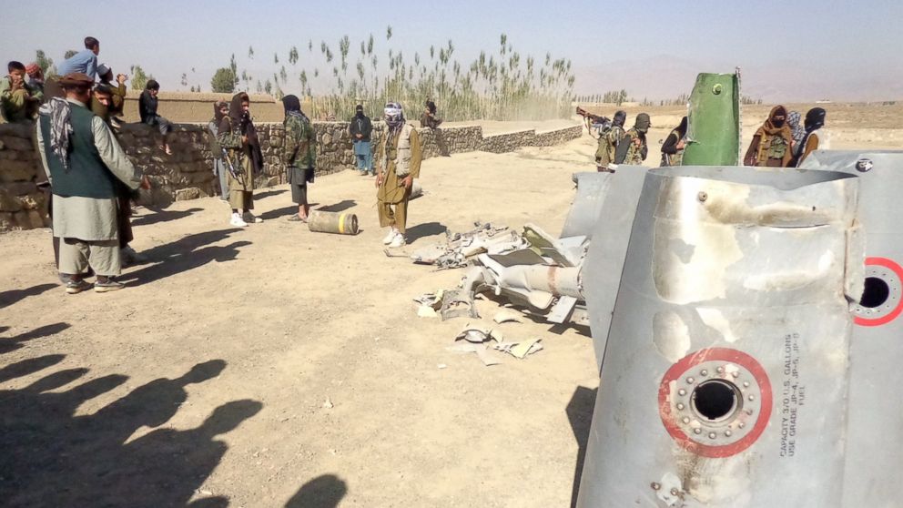PHOTO: In this photograph taken on Oct.13, 2015, Afghan Taliban militants gather around parts of a US F-16 aircraft that was struck over in Sayid Karam district of eastern Paktia province.