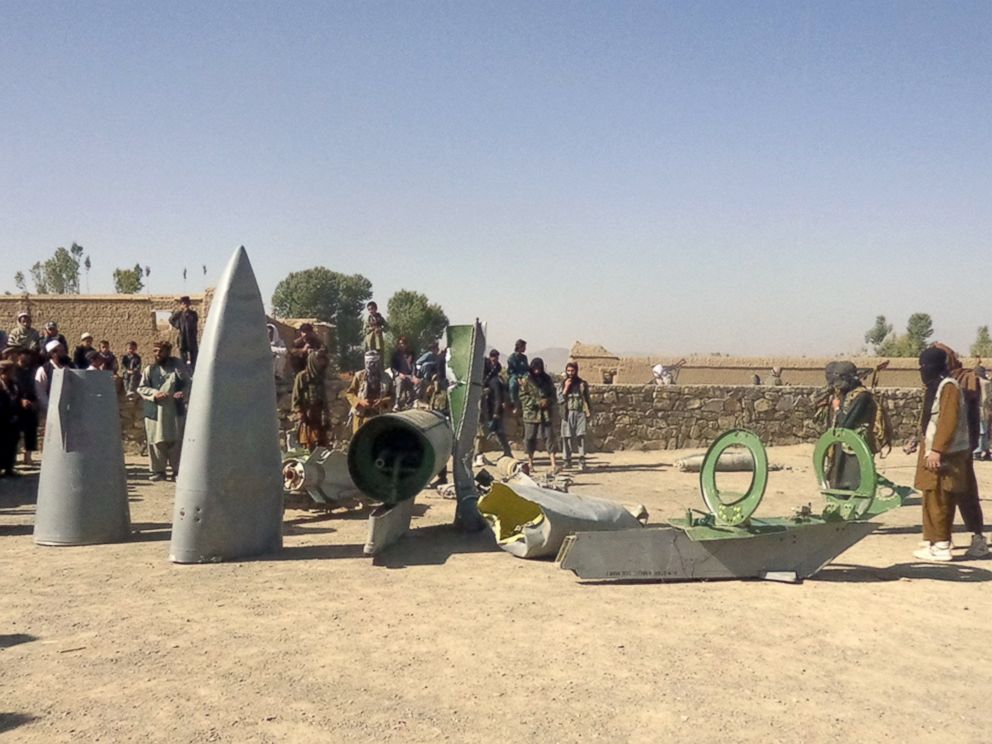 PHOTO: In this photograph taken on Oct.13, 2015, Afghan Taliban militants gather around parts of a US F-16 aircraft that was struck over in Sayid Karam district of eastern Paktia province.
