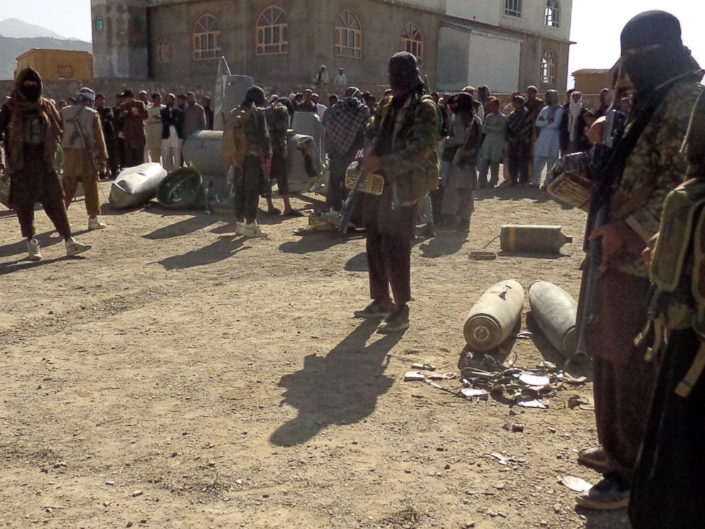 PHOTO: In this photograph taken on Oct.13, 2015, Afghan Taliban militants gather around parts of a US F-16 aircraft that was struck over in Sayid Karam district of eastern Paktia province.