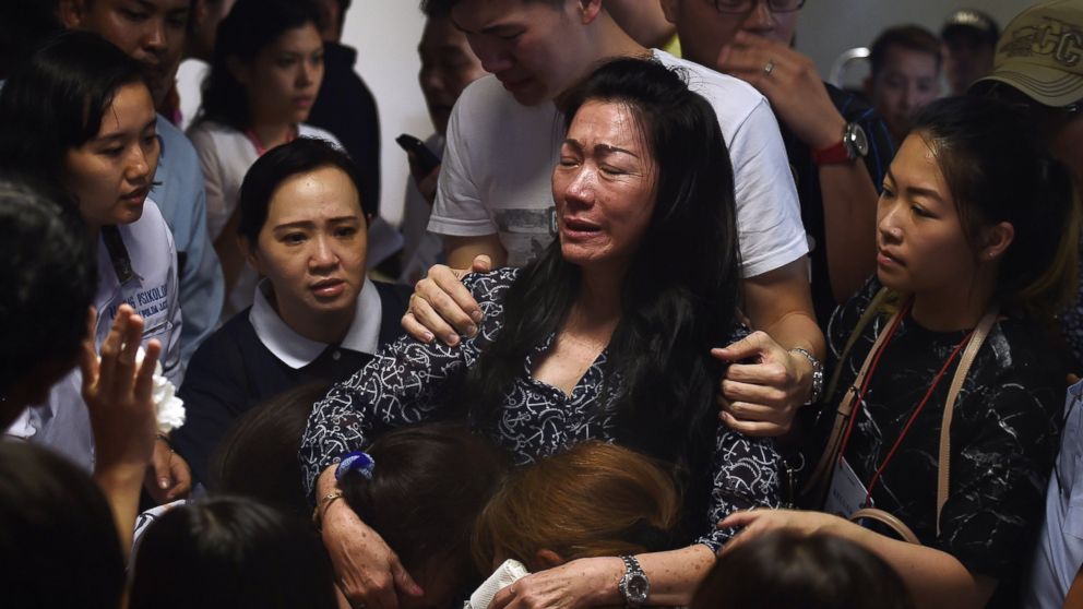 PHOTO: Family members of passengers onboard the missing air carrier AirAsia flight QZ8501 react after watching news reports inside the crisis center set up at Juanda International Airport in Surabaya on Dec. 30, 2014.