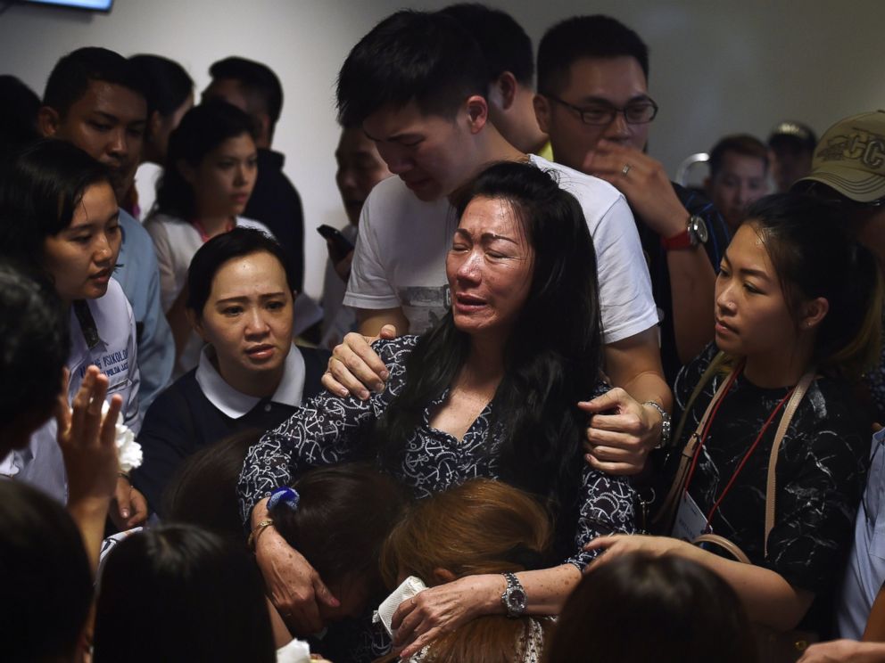 PHOTO: Family members of passengers onboard the missing air carrier AirAsia flight QZ8501 react after watching news reports inside the crisis center set up at Juanda International Airport in Surabaya on Dec. 30, 2014.