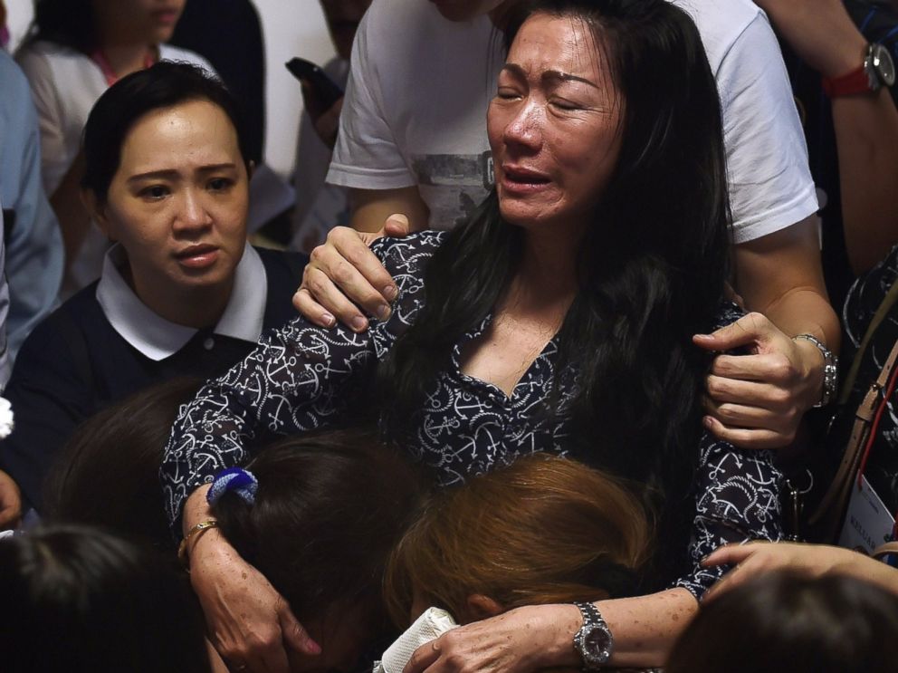 PHOTO: Family members of passengers onboard the missing air carrier AirAsia flight QZ8501 react after watching news reports inside the crisis center set up at Juanda International Airport in Surabaya on Dec. 30, 2014.